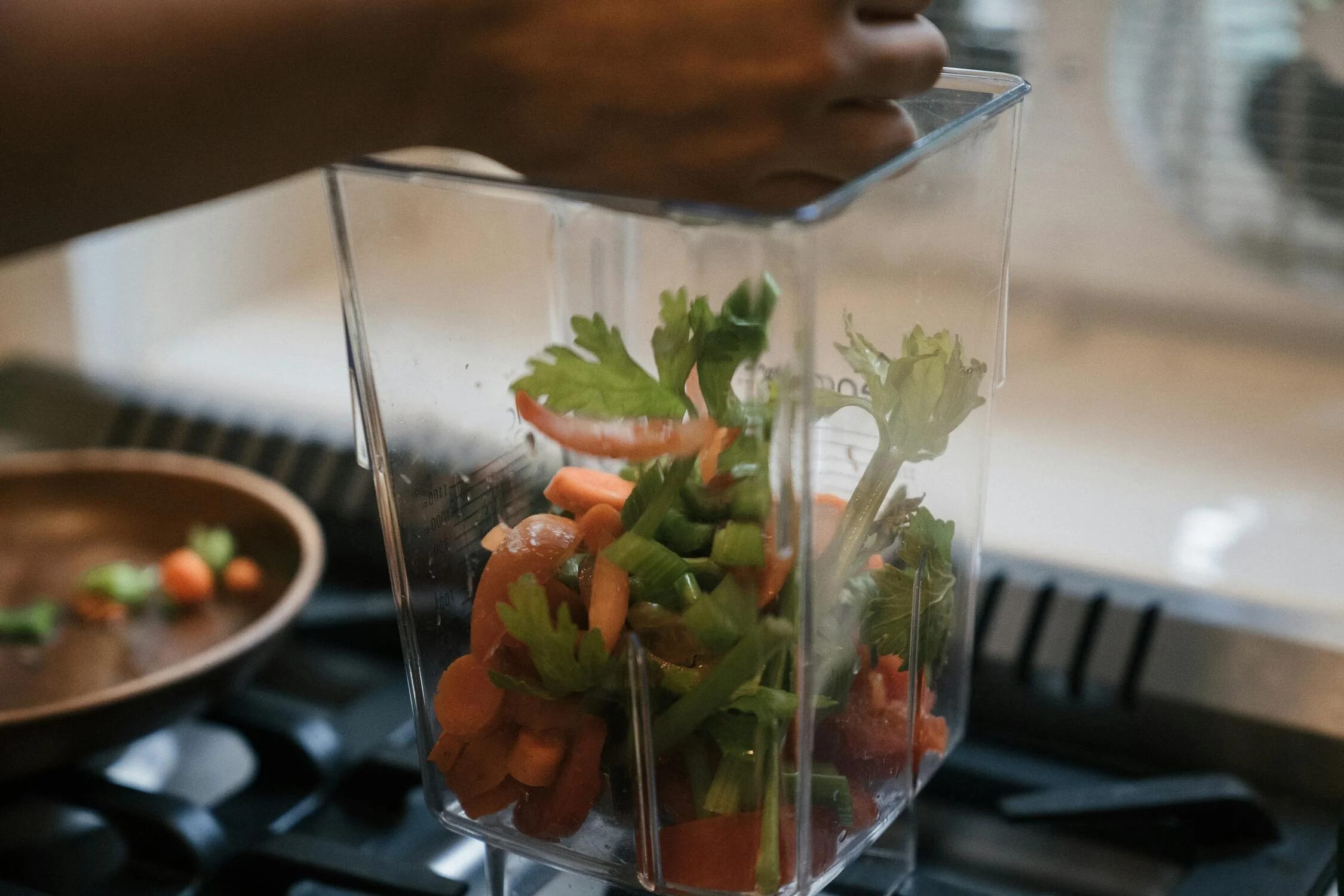 Close-up of Person Putting Freshly Cut Vegetables into a Plastic Container