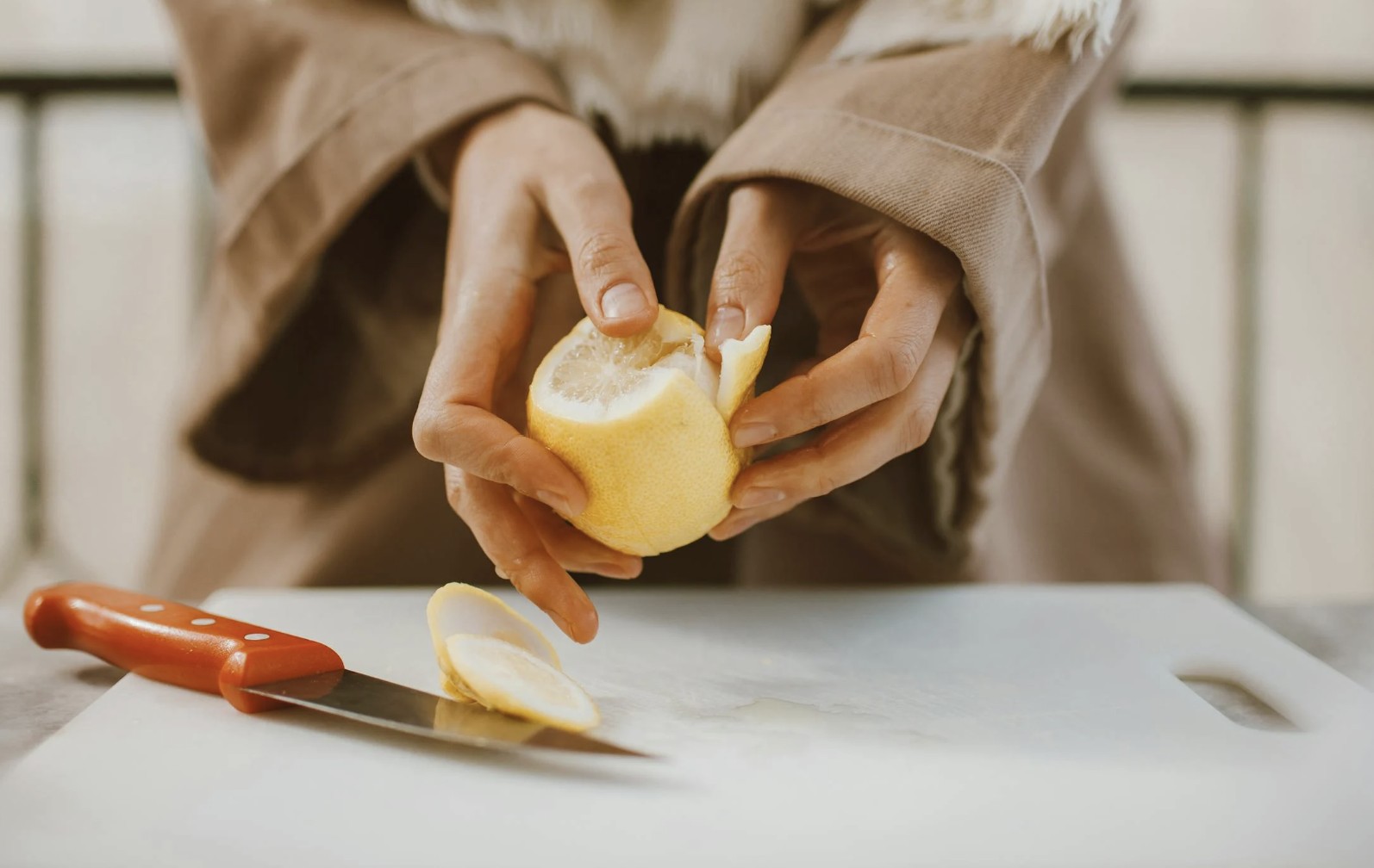 a person peeling a lemon