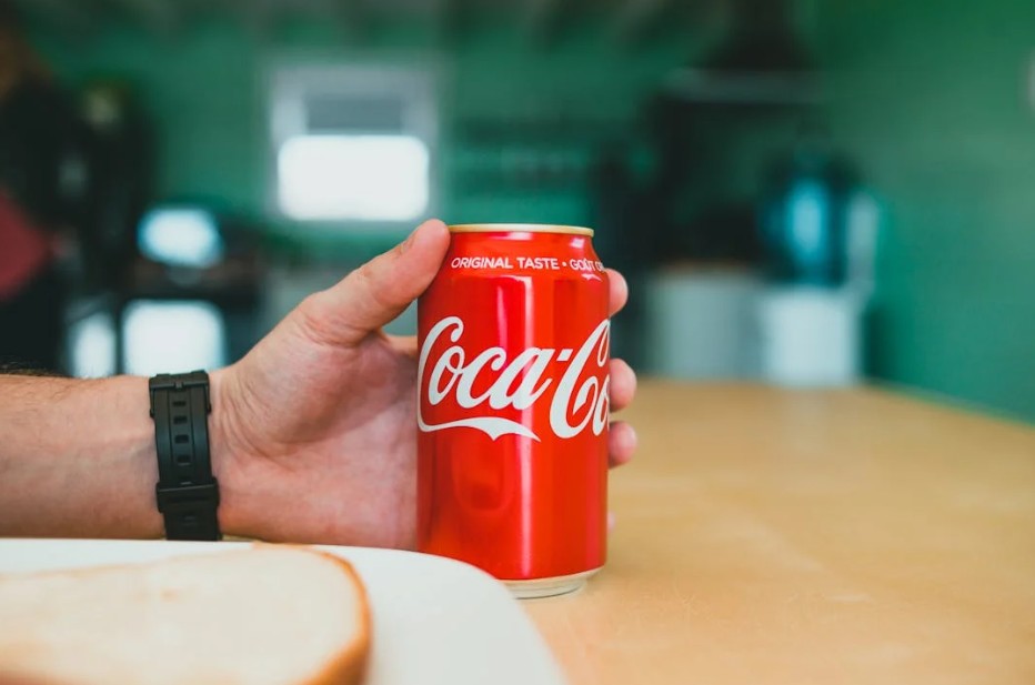 holding a coca cola