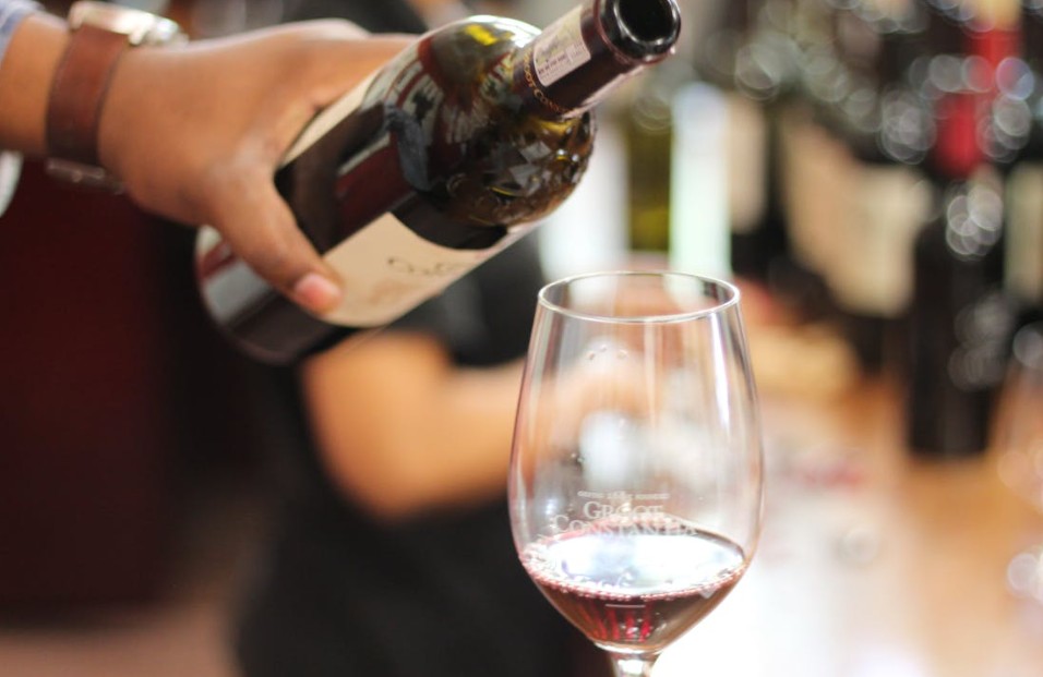 person pouring wine