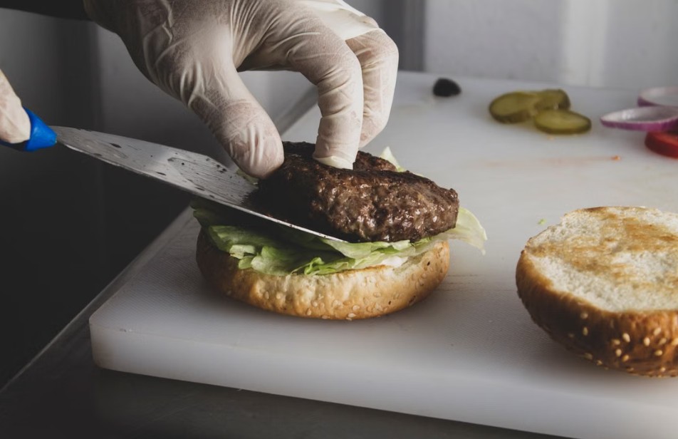 putting beef on a sandwich