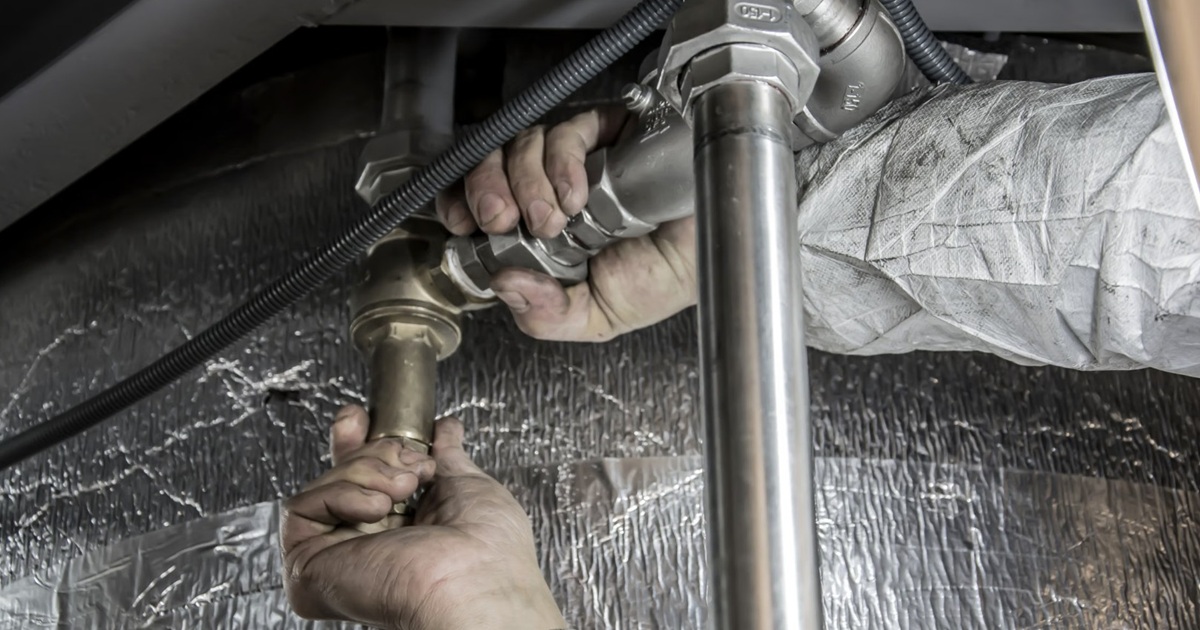 plumber fixing pipes